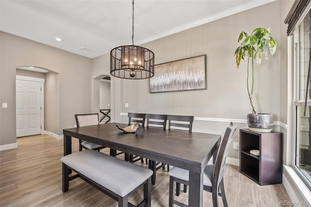 10553 Stonemeadow Dr, Parker, CO 80134 - dining space featuring arched walkways, light wood-type flooring, a chandelier, ornamental molding, and recessed lighting