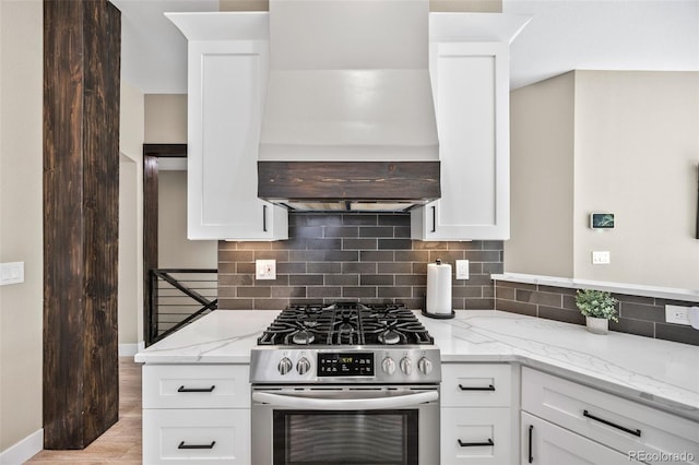 10553 Stonemeadow Dr, Parker, CO 80134 - kitchen featuring stainless steel range with gas cooktop, custom exhaust hood, tasteful backsplash, and light stone countertops