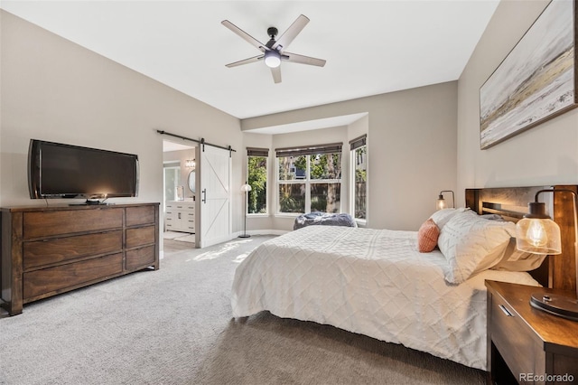 10553 Stonemeadow Dr, Parker, CO 80134 - carpeted bedroom with a barn door, ensuite bath, and ceiling fan