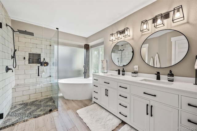 10553 Stonemeadow Dr, Parker, CO 80134 - full bathroom with double vanity, a shower stall, a freestanding bath, and wood finished floors