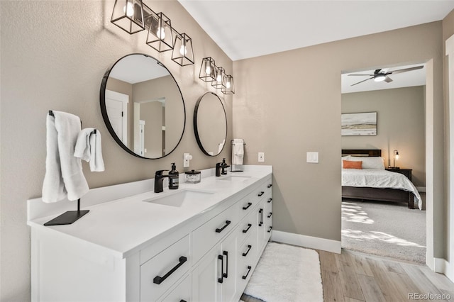 10553 Stonemeadow Dr, Parker, CO 80134 - bathroom with wood finished floors, double vanity, ceiling fan, and connected bathroom