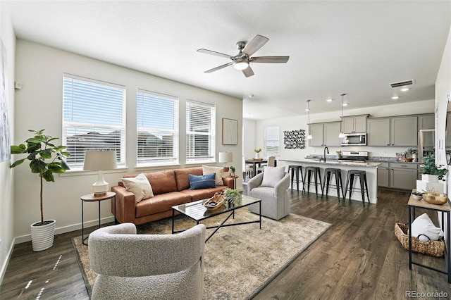 226 Racer St, Bennett, CO 80102 - living area featuring a ceiling fan, dark wood finished floors, and recessed lighting