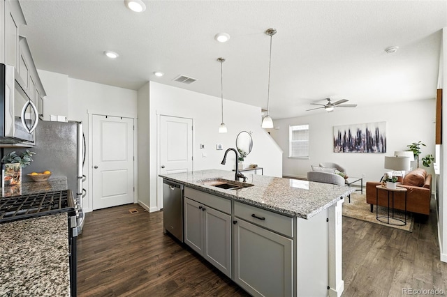 226 Racer St, Bennett, CO 80102 - kitchen featuring appliances with stainless steel finishes, gray cabinets, dark wood-style flooring, ceiling fan, and recessed lighting