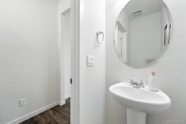 226 Racer St, Bennett, CO 80102 - bathroom with wood finished floors and a textured wall