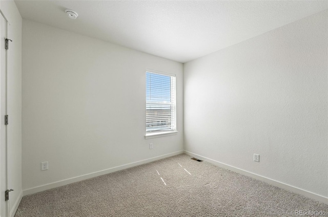 226 Racer St, Bennett, CO 80102 - spare room featuring a smoke detector and light carpet