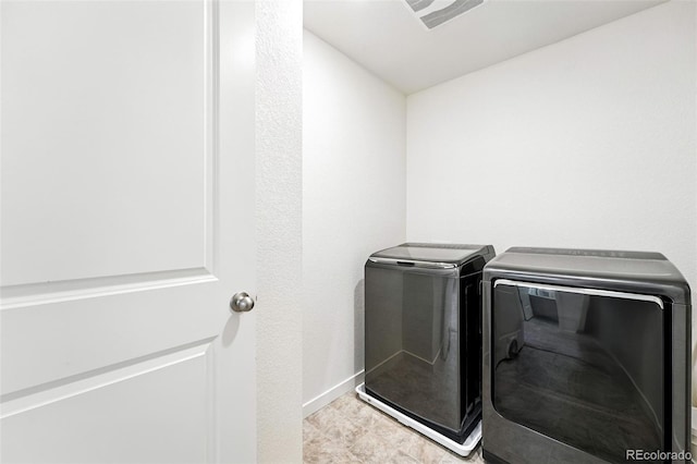 226 Racer St, Bennett, CO 80102 - laundry area featuring washer and clothes dryer and baseboards