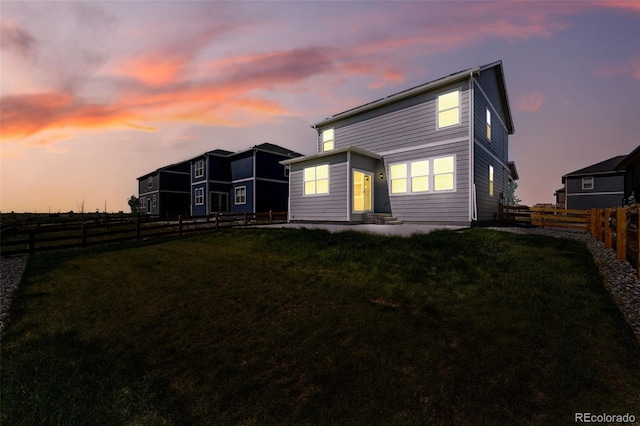 226 Racer St, Bennett, CO 80102 - back of property at dusk featuring a fenced backyard
