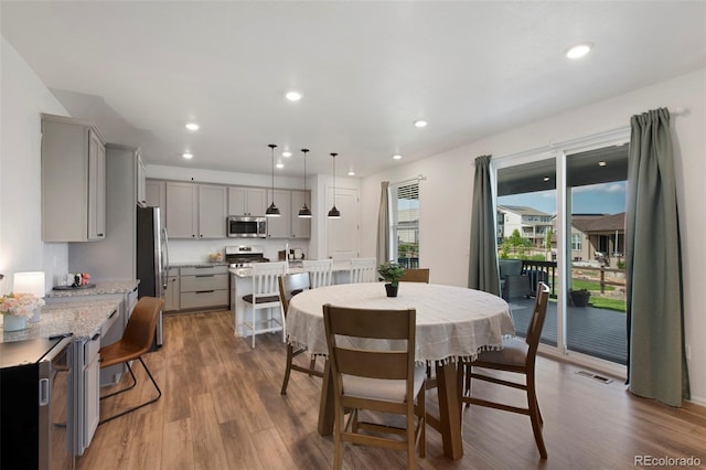 12826 Lake Port St, Longmont, CO 80504 - dining area featuring wood finished floors and recessed lighting
