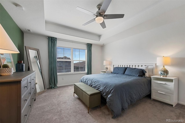 12826 Lake Port St, Longmont, CO 80504 - bedroom featuring light carpet, a ceiling fan, and a raised ceiling