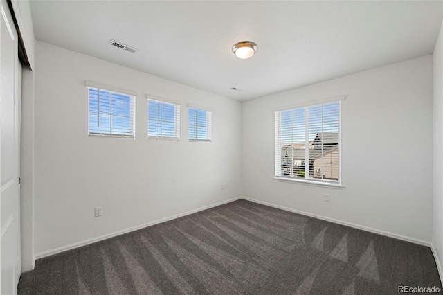 12826 Lake Port St, Longmont, CO 80504 - unfurnished room featuring dark colored carpet and baseboards