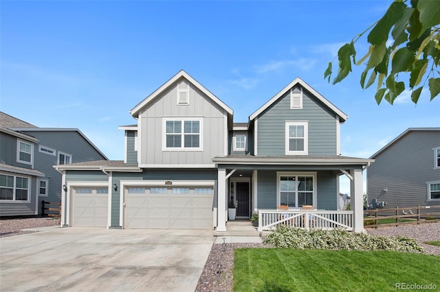 12826 Lake Port St, Longmont, CO 80504 - view of front of house featuring concrete driveway, a porch, board and batten siding, and a garage