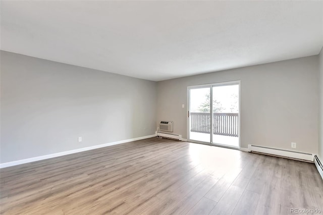 empty room with a baseboard radiator and light hardwood / wood-style flooring