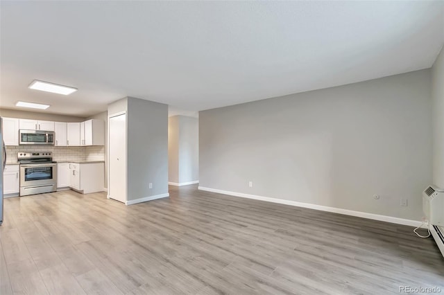 unfurnished living room featuring light wood-type flooring