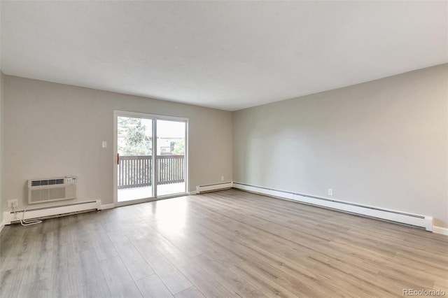 unfurnished room with light hardwood / wood-style flooring, a wall mounted air conditioner, and a baseboard radiator