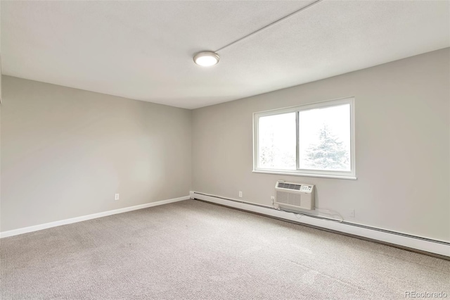 unfurnished room with carpet floors, a baseboard heating unit, and an AC wall unit