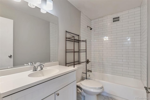 full bathroom featuring tiled shower / bath combo, vanity, and toilet