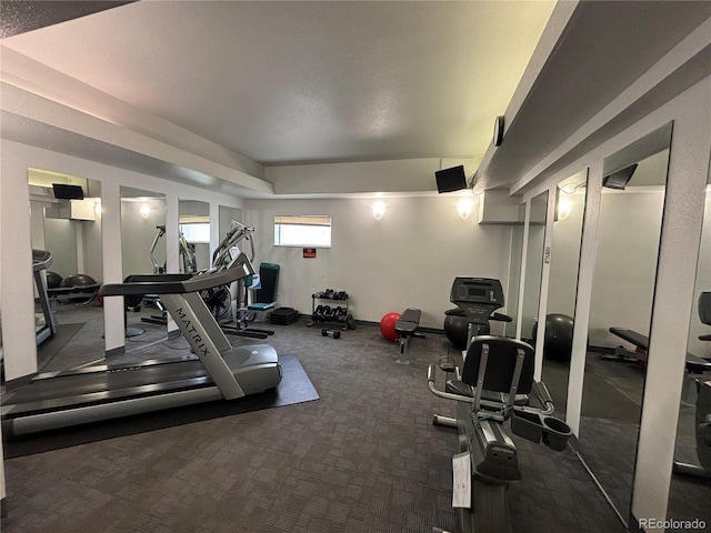 exercise room featuring dark colored carpet