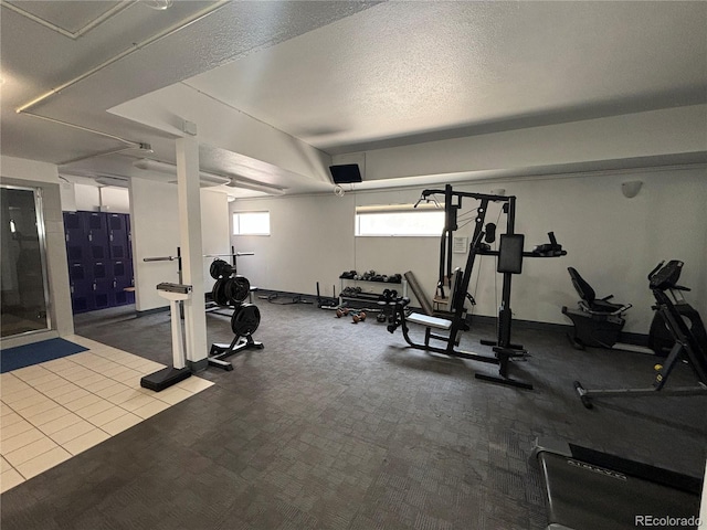 workout room with carpet and a textured ceiling