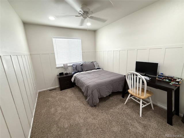 3771 S Kirk Way, Aurora, CO 80013 - carpeted bedroom with a wainscoted wall, a decorative wall, and a ceiling fan