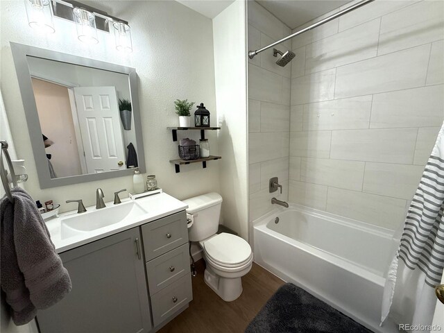 3771 S Kirk Way, Aurora, CO 80013 - full bathroom with wood finished floors, shower / bath combination with curtain, and vanity