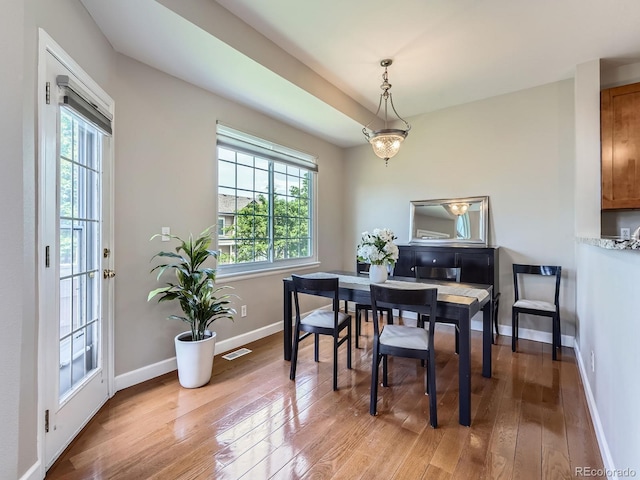 6827 S Webster St Unit E, Littleton, CO 80128 - dining area with light wood finished floors and baseboards