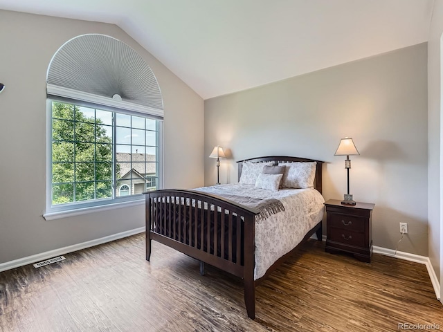 6827 S Webster St Unit E, Littleton, CO 80128 - bedroom featuring wood finished floors and vaulted ceiling