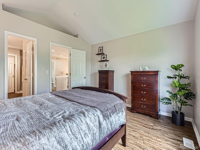 6827 S Webster St Unit E, Littleton, CO 80128 - bedroom featuring vaulted ceiling and light wood finished floors
