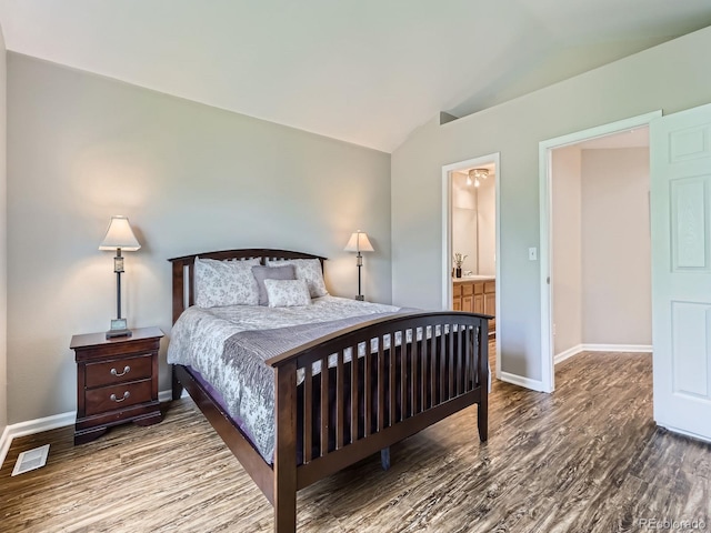 6827 S Webster St Unit E, Littleton, CO 80128 - bedroom featuring vaulted ceiling, wood finished floors, and ensuite bath