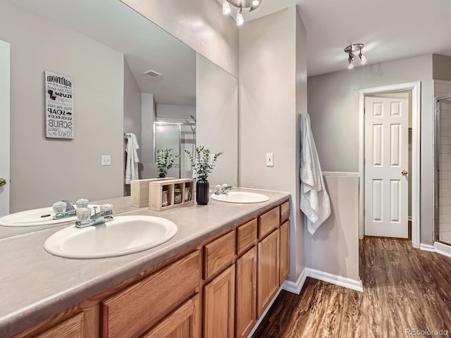 6827 S Webster St Unit E, Littleton, CO 80128 - bathroom with wood finished floors, a shower stall, and double vanity