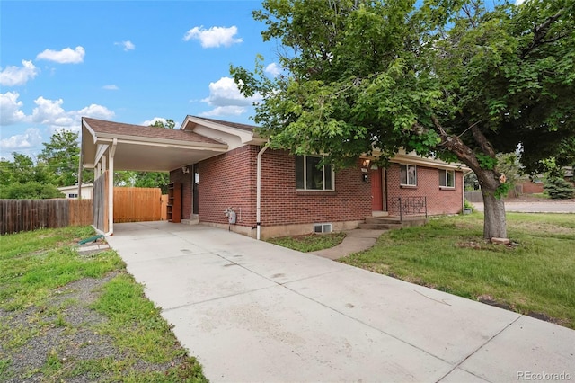 6698 S Wellington Ct, Centennial, CO 80121 - view of front of home with brick siding, concrete driveway, and an attached carport