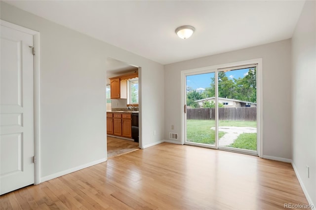 6698 S Wellington Ct, Centennial, CO 80121 - unfurnished living room featuring light wood finished floors, a sink, and baseboards