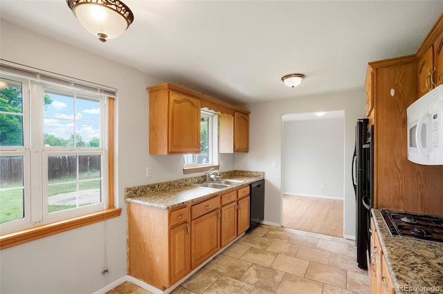 6698 S Wellington Ct, Centennial, CO 80121 - kitchen with black appliances, a sink, baseboards, and brown cabinetry