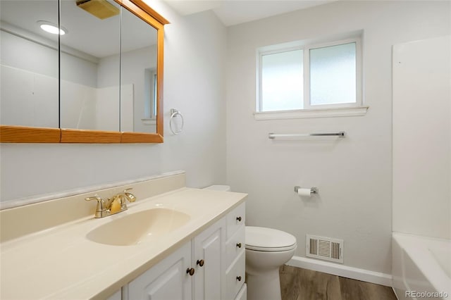 6698 S Wellington Ct, Centennial, CO 80121 - full bathroom with baseboards, vanity, toilet, wood finished floors, and a bathtub