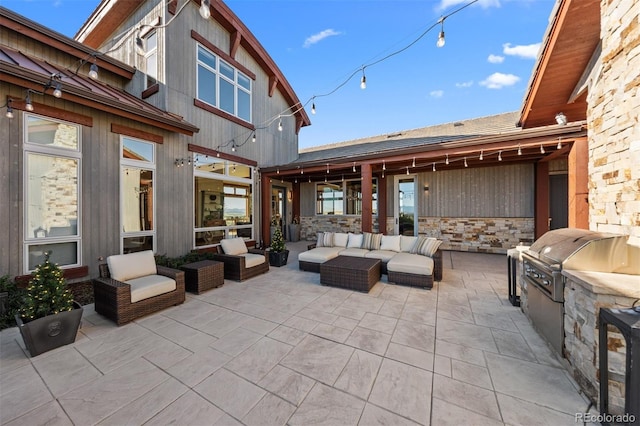 view of patio with area for grilling, grilling area, and an outdoor living space