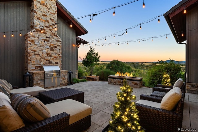 patio terrace at dusk featuring an outdoor hangout area, area for grilling, and a grill