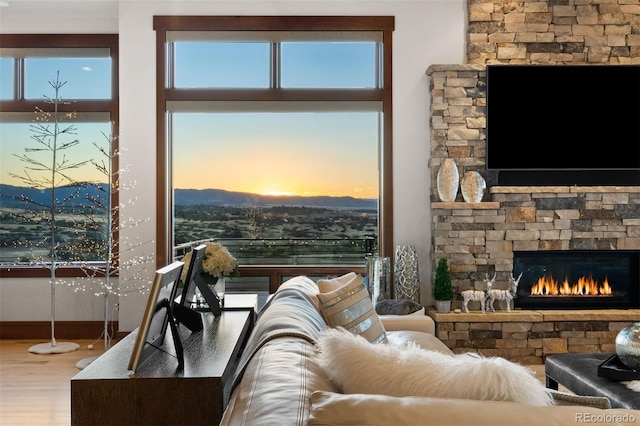 living room featuring a mountain view, hardwood / wood-style flooring, and a fireplace