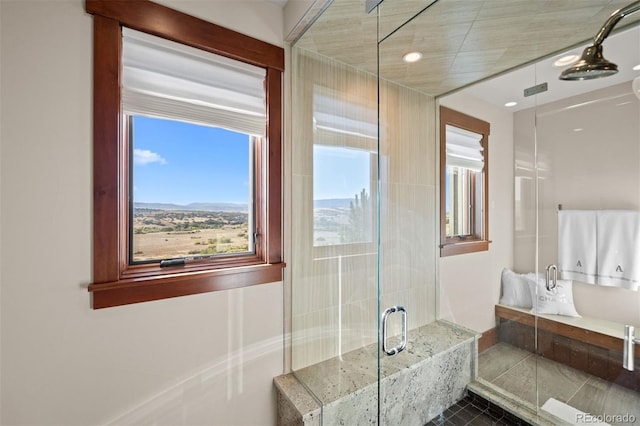 bathroom with tile patterned flooring, a mountain view, and a shower with shower door