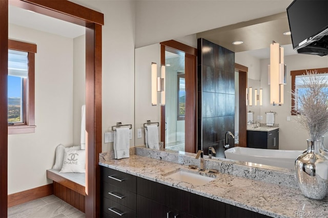 bathroom featuring vanity, a bathtub, and tile patterned flooring