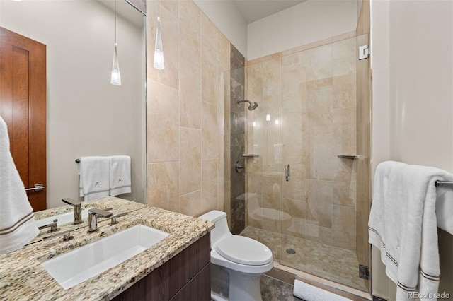 bathroom with vanity, toilet, and an enclosed shower