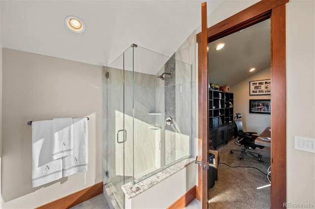 bathroom with vaulted ceiling and a shower with shower door