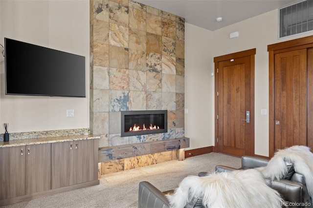 carpeted living room featuring a fireplace