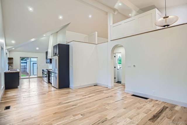 3975 Yates St, Denver, CO 80212 - kitchen with high vaulted ceiling, arched walkways, light wood-style floors, beam ceiling, and recessed lighting