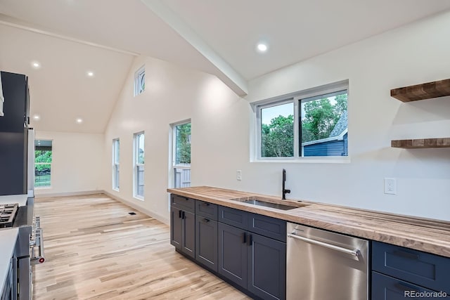 3975 Yates St, Denver, CO 80212 - kitchen featuring stainless steel dishwasher, wood counters, open shelves, healthy amount of natural light, and high vaulted ceiling