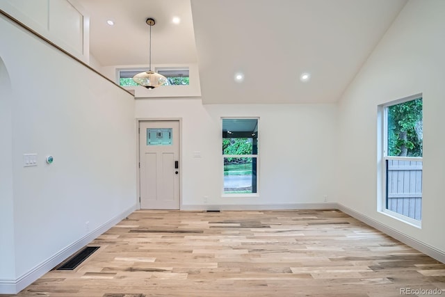 3975 Yates St, Denver, CO 80212 - entryway with high vaulted ceiling, arched walkways, light wood-style floors, and recessed lighting