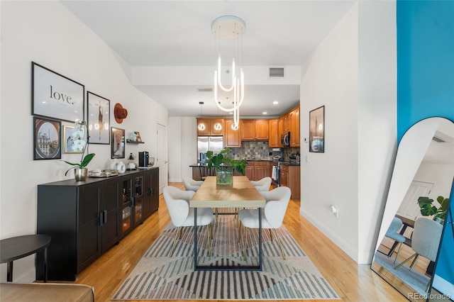 1950 N Logan St Unit 905, Denver, CO 80203 - dining room with light wood-style flooring and baseboards