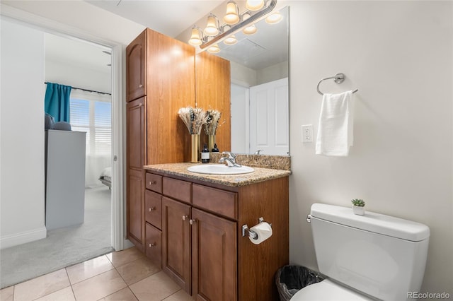 1950 N Logan St Unit 905, Denver, CO 80203 - bathroom with vanity, toilet, and tile patterned flooring