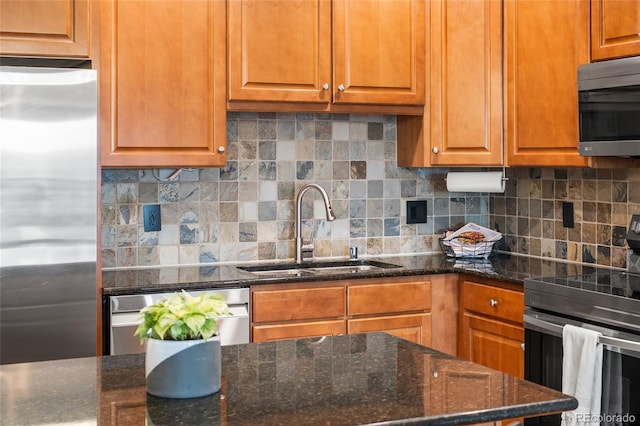 1950 N Logan St Unit 905, Denver, CO 80203 - kitchen with stainless steel appliances, a sink, decorative backsplash, and dark stone countertops