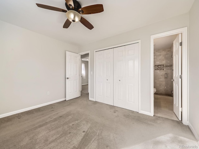 unfurnished bedroom featuring carpet, a closet, ceiling fan, ensuite bath, and baseboards