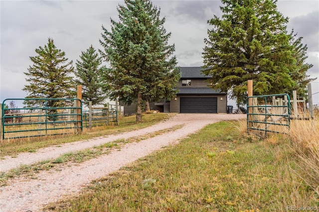 view of property hidden behind natural elements with dirt driveway, a garage, and fence