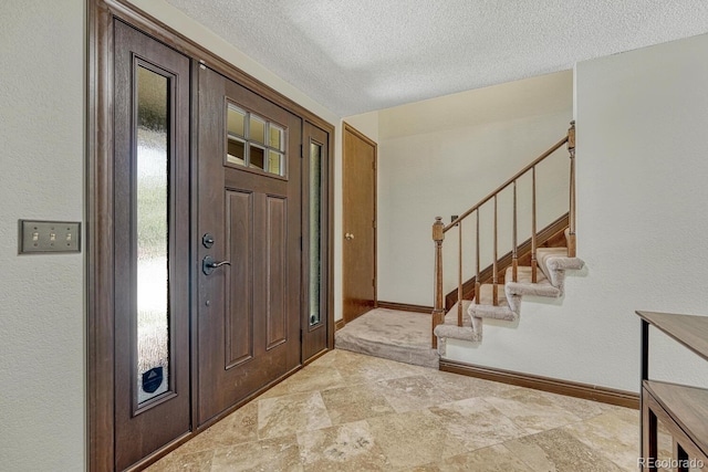 302 Northridge Rd, Highlands Ranch, CO 80126 - foyer featuring baseboards, a textured ceiling, stairway, and stone finish flooring
